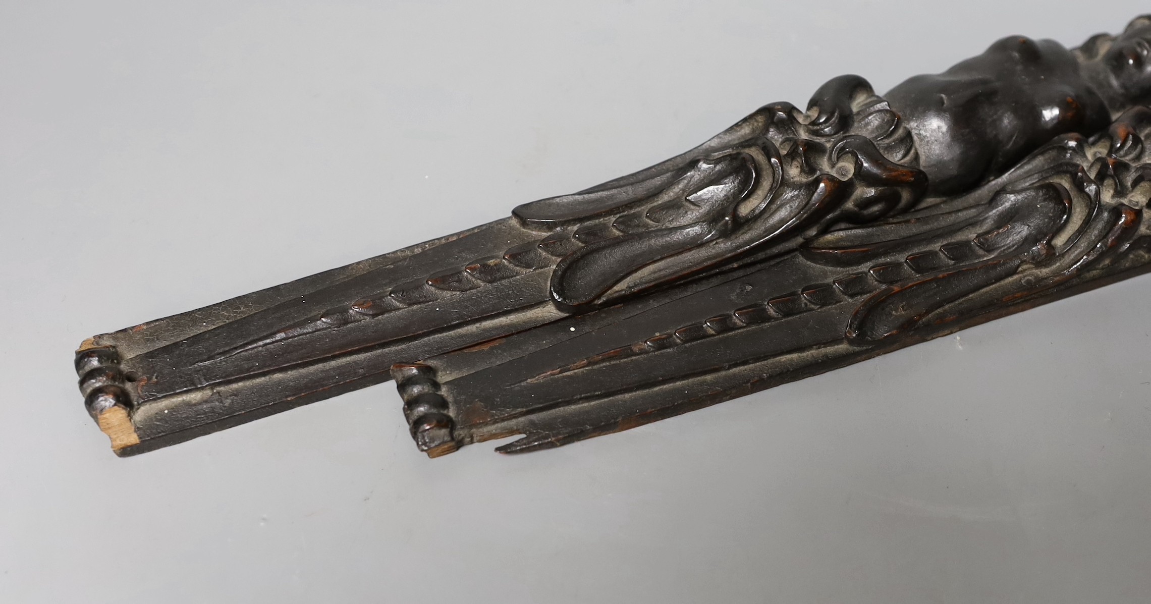 A pair of 18th century French carved walnut appliques, 39.5 cms long